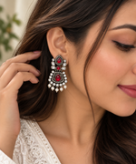Load image into Gallery viewer, Oxidised silver earrings with red teardrop stones and clear stone detailing
