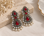 Load image into Gallery viewer, Traditional oxidised earrings featuring red stones and intricate silver detailing
